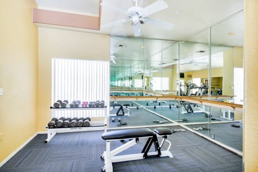 Weight training at the fitness center, gym at Ventana Apartment Homes in Central Scottsdale, AZ, For Rent. Now leasing 1 and 2 bedroom apartments.