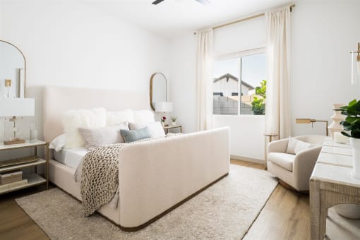 a bedroom with a bed and a couch and a window at Villas on Ash, Gilbert, AZ  