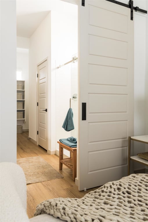 a bedroom with a bed and a closet with a white door at Villas on Ash, Gilbert  