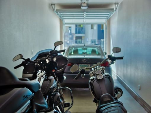 apartment garage showing two motorcycles in the foreground and Carat Craft at Gilbert and Baseline, Mesa, 85204  