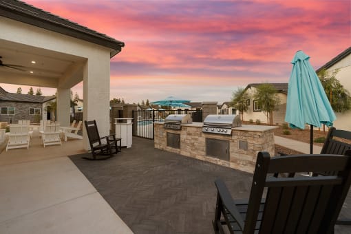 a patio with a grill and a bar with umbrellas at Villas on Ash, Gilbert, AZ  