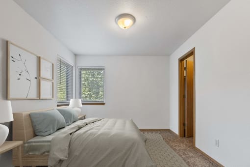 a bedroom with a bed and a window