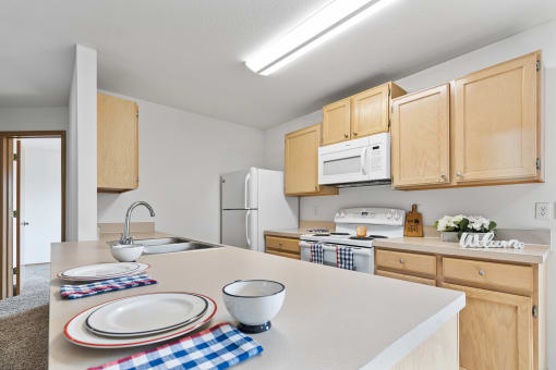 a kitchen with wooden cabinets and white appliances