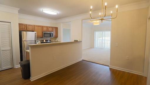 A kitchen with wooden cabinets and a refrigerator.