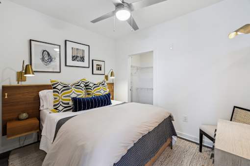 a bedroom with a large bed and a ceiling fan at Link Apartments® Broad Ave, Memphis, Tennessee