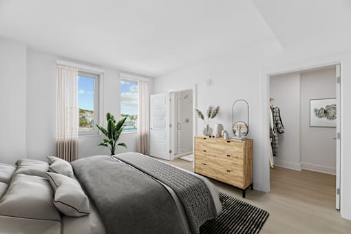 a bedroom with a bed and a dresser  at Link Apartments® H Street, Washington, 20002