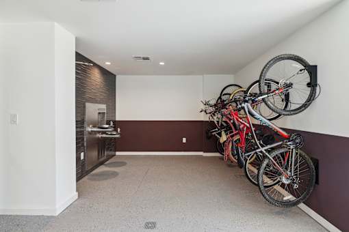 a group of bikes hanging on the wall in a room at Link Apartments® Broad Ave, Memphis, 38112