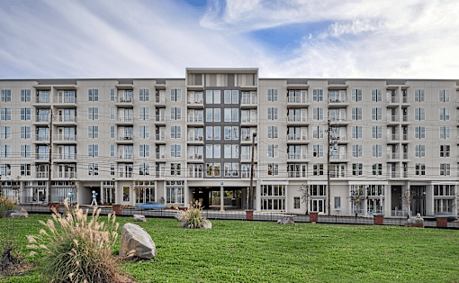 a large apartment building with a grassy area in front of it at Link Apartments® Canvas, Georgia