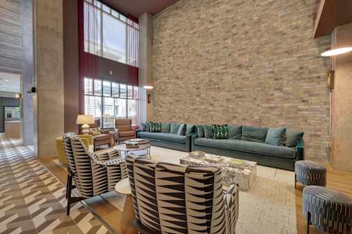 a living room with couches and chairs and a table at Link Apartments® Broad Ave, Memphis