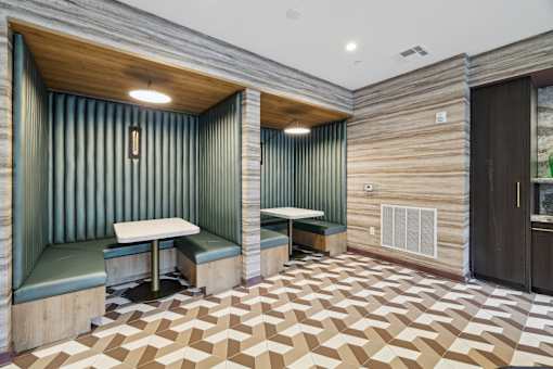 a tasting room with two booths and a wooden floor and green walls at Link Apartments® Broad Ave, Tennessee
