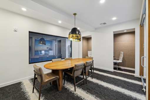 a dining room with a wooden table and chairs at Link Apartments® Broad Ave, Tennessee
