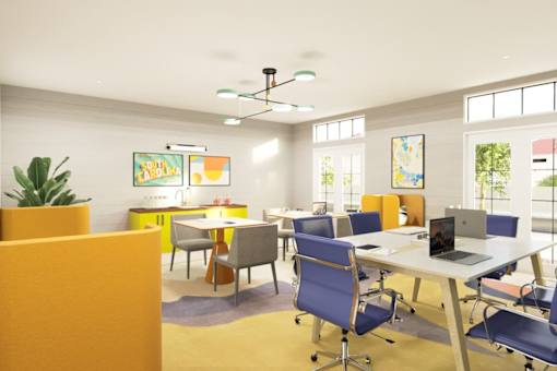 a room filled with tables and chairs and a laptop on a table  at Link Apartments® Mixson, North Charleston, SC, 29405
