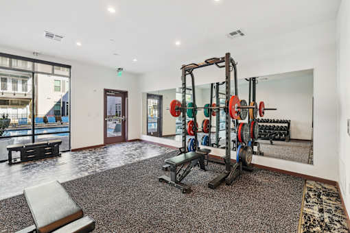 a gym with weights and dumbbells in the corner of a room at Link Apartments® Broad Ave, Tennessee