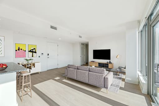 a living room with a couch and a tv  at Link Apartments® H Street, Washington, DC