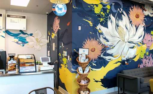 a mural of flowers on a blue and yellow background at Link Apartments® Canvas, Atlanta, GA