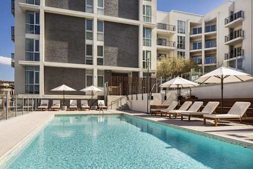 A large swimming pool in front of a modern building.