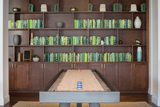 A shelf with books and vases on it.