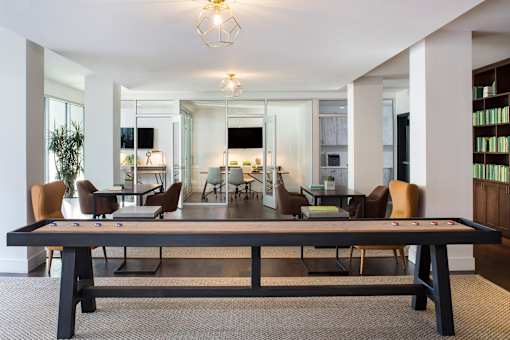A conference room with a long table and chairs.
