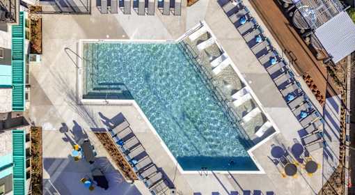 A large swimming pool with a staircase leading down to it.