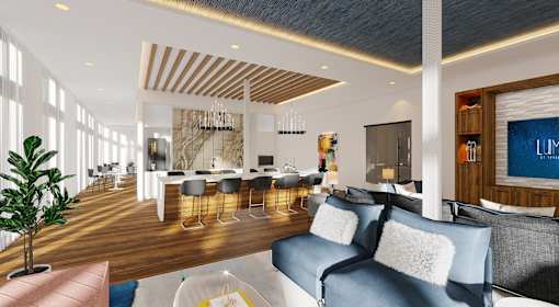 A modern living room with a blue sofa and a wooden floor.