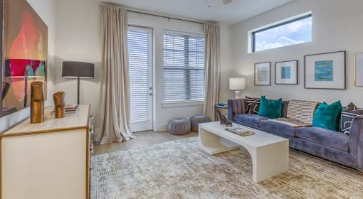 A living room with a grey couch and a white coffee table.