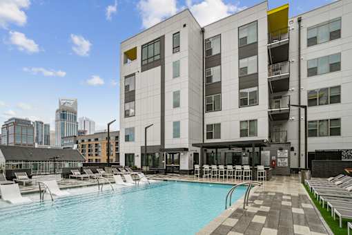 a swimming pool in front of a building at Link Apartments® Mint Street, Charlotte