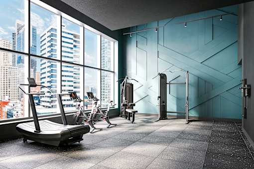 A gym with a view of the cityscape outside the large windows.