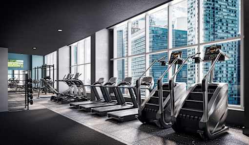 A gym with treadmills and a view of the city.