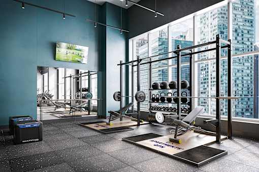 A gym with a view of the city outside the window.