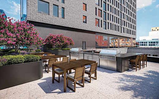 A patio with a table and chairs is in front of a building.