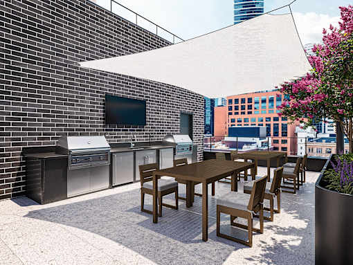 A patio with a table and chairs and a TV on the wall.