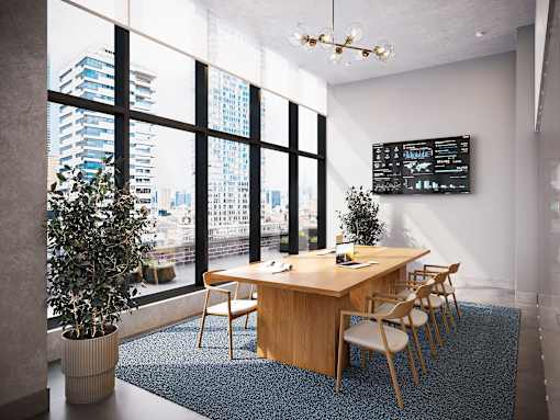 A conference room with a long table, chairs, and a large window overlooking a cityscape.
