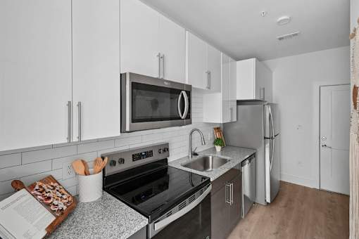 Modern kitchen with stainless steel appliances at Link ® Lake Park Apartments, Smyrna, 30080