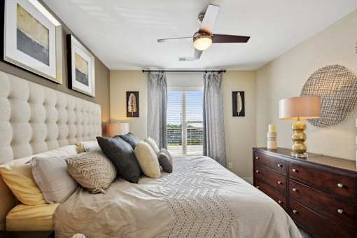 a bedroom with a large bed and a ceiling fan at Link Apartments® Brookstown, North Carolina