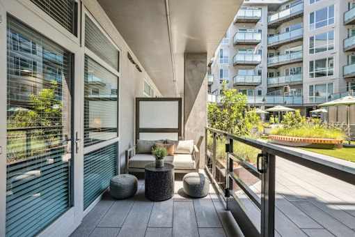 the condo has a private balcony with a view of the city at Link Apartments® Four 12, Oakland, 94607