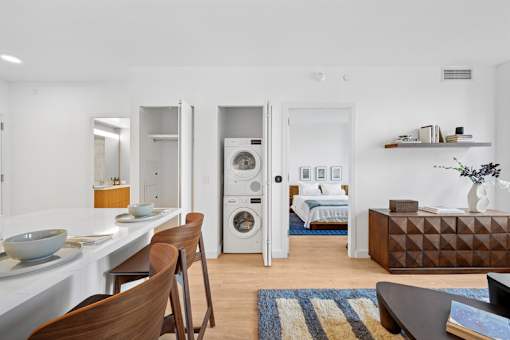 A modern kitchen with a dining table and chairs.at Link Apartments® QPN, Long Island City New York