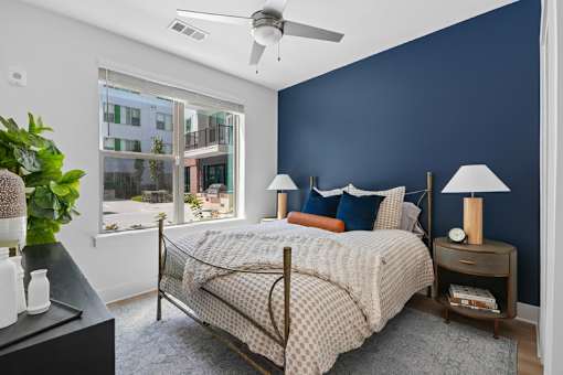 Modern bedroom with navy accent wall at Link ® Lake Park Apartments, Georgia