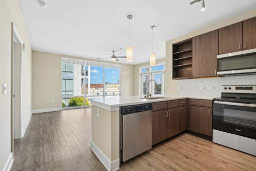 Modern kitchen with white countertops and pendant lighting at Link ® West End Apartments, Greenville, SC 29601