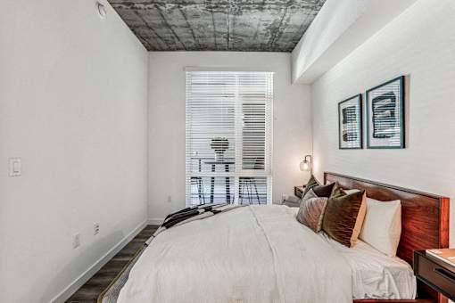 a bedroom with a large bed and a window at Link Apartments® Four 12, Oakland, CA, 94607