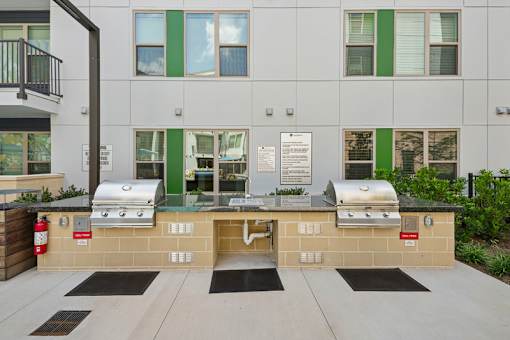 Outdoor grilling area with twin barbecue stations at Link ® Lake Park Apartments, Smyrna, GA 30080