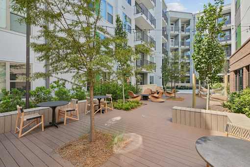 Courtyard with seating areas and trees at Link ® Lake Park Apartments, Smyrna, GA