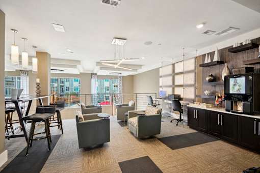 a living room with couches chairs and a bar and a television at Link Apartments® Brookstown, North Carolina, 27101