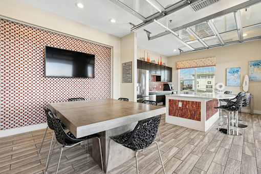 Community kitchen with dining table and island seating at Link ® West End Apartments, Greenville