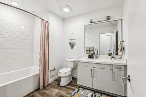 a bathroom with a shower toilet and a sink at Link Apartments® Four 12, Oakland, CA, 94607
