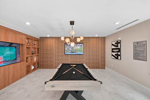 Game room with pool table and entertainment screens at Link ® Lake Park Apartments, Smyrna, Georgia