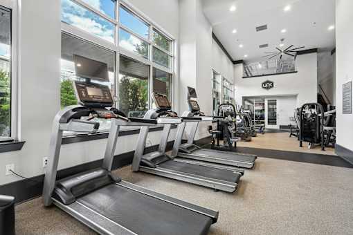 Fitness center with treadmills and large windows at Link ® West End Apartments, Greenville, 29601