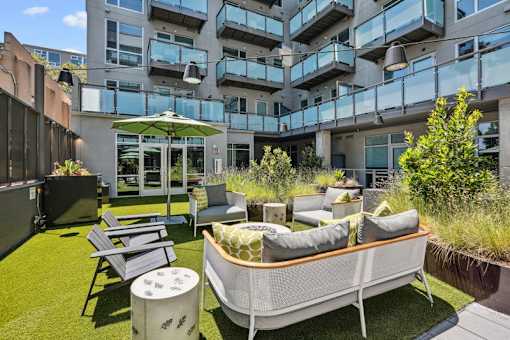 an outdoor patio with furniture and a table and chairs at Link Apartments® Four 12, California