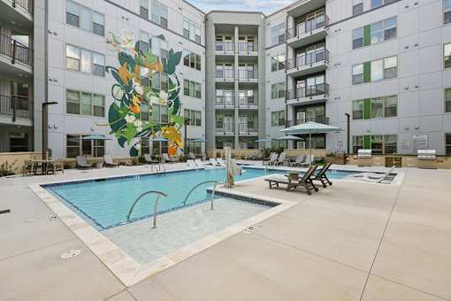 Courtyard pool with mural and lounge chairs at Link ® Lake Park Apartments, Smyrna, Georgia