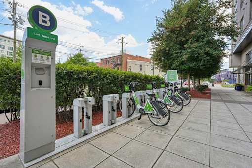 Bike share station with docked bicycles at Link ® West End Apartments, South Carolina, 29601