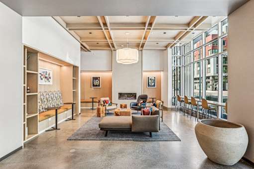 the lobby of a building with a living room and a fireplace at Link Apartments® Four 12, Oakland